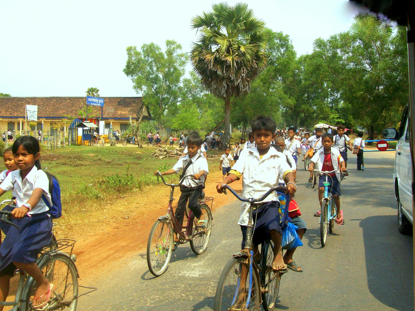 School children on the road between Luang Prabang & Banteay Srey outlying temple = Cambodia