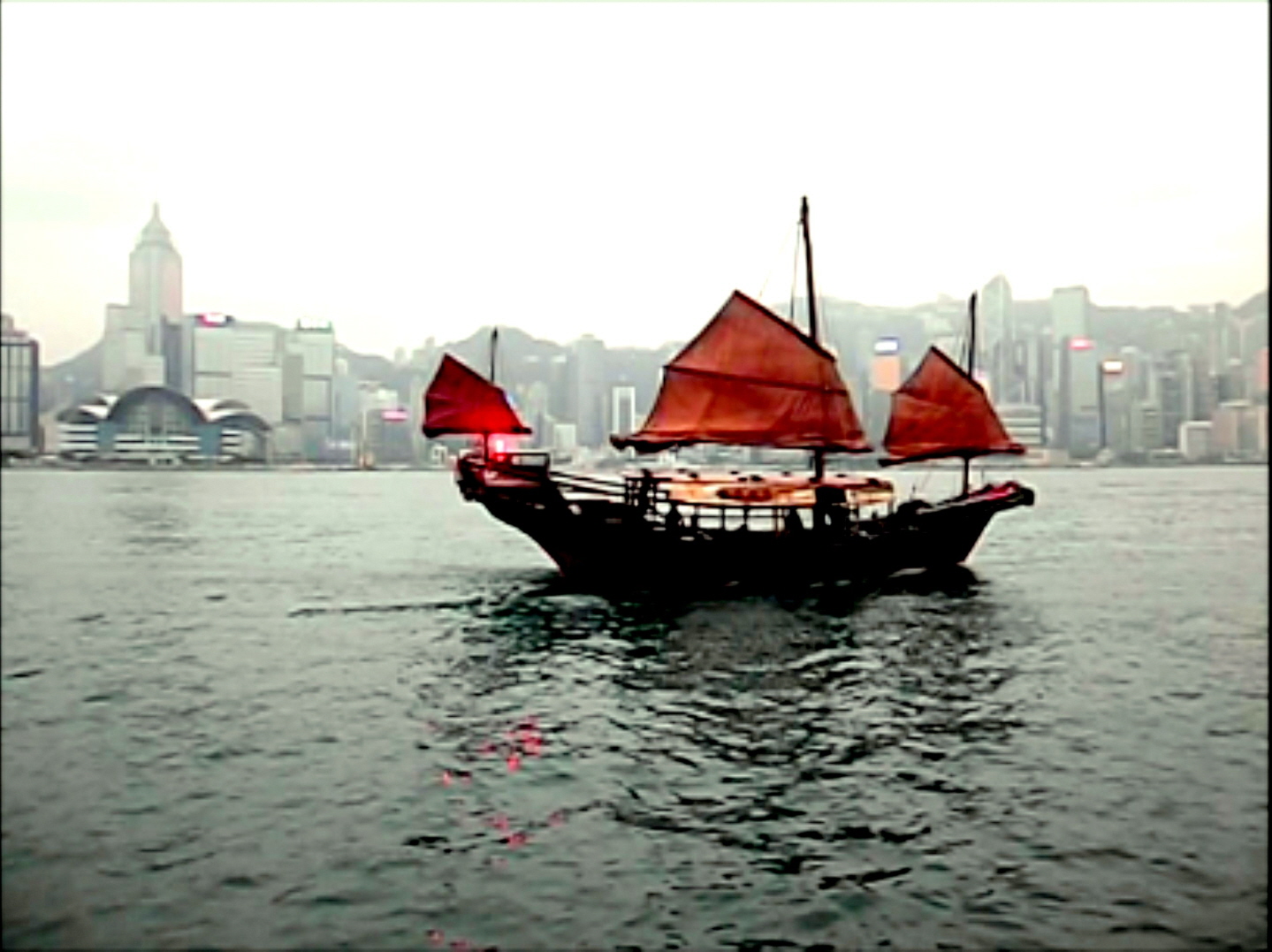 Old Fashioned Junk in Harbor - Hong Kong Skyline (Still taken from Video)