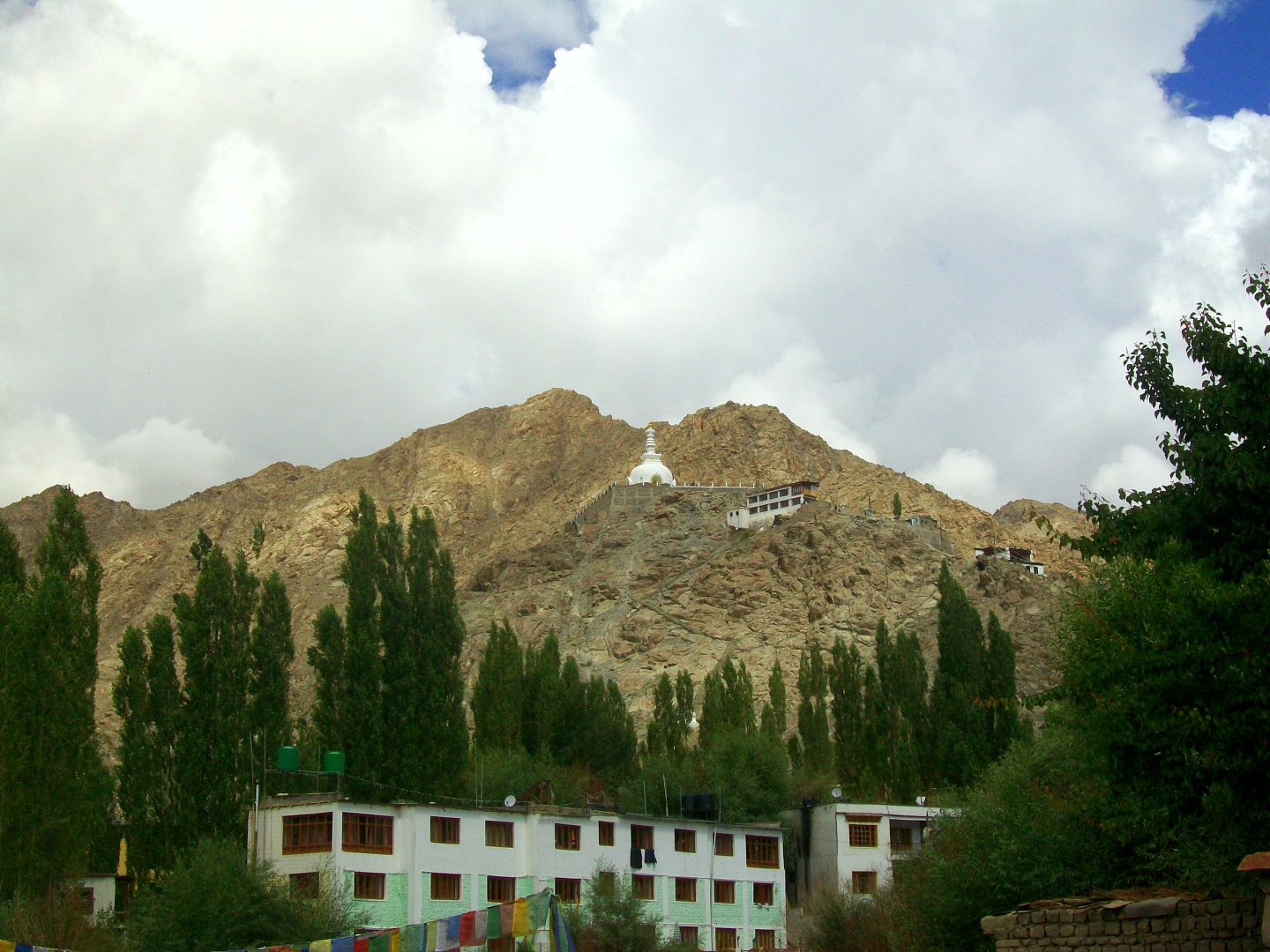 Stupa Gompa (Monastery) on Mountain - a hotel below - Leh, Ladakh- India